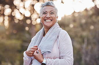 Active woman working out and smiling at the camera.