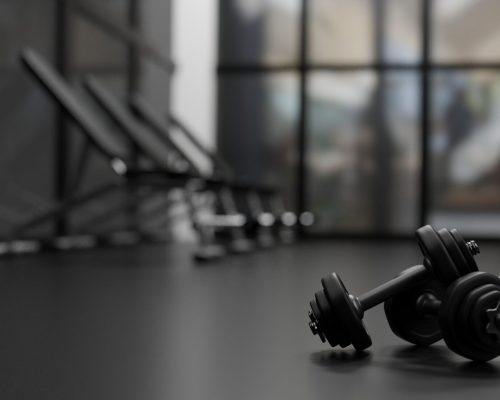 3D rendering, dumbbells on the floor in concept fitness room with training equipments in the back